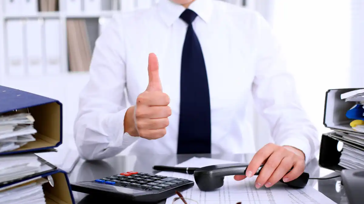 Audit and insurance services close-up of businesswoman showing ok sign while making report calculating or checking balance